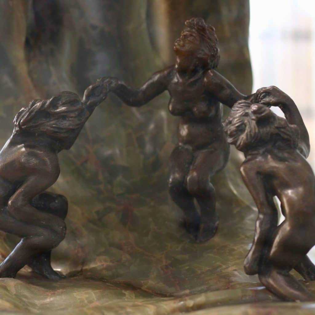 Onyx sculpture representing three women dancing under a huge wave by female sculptor Camille Claudel